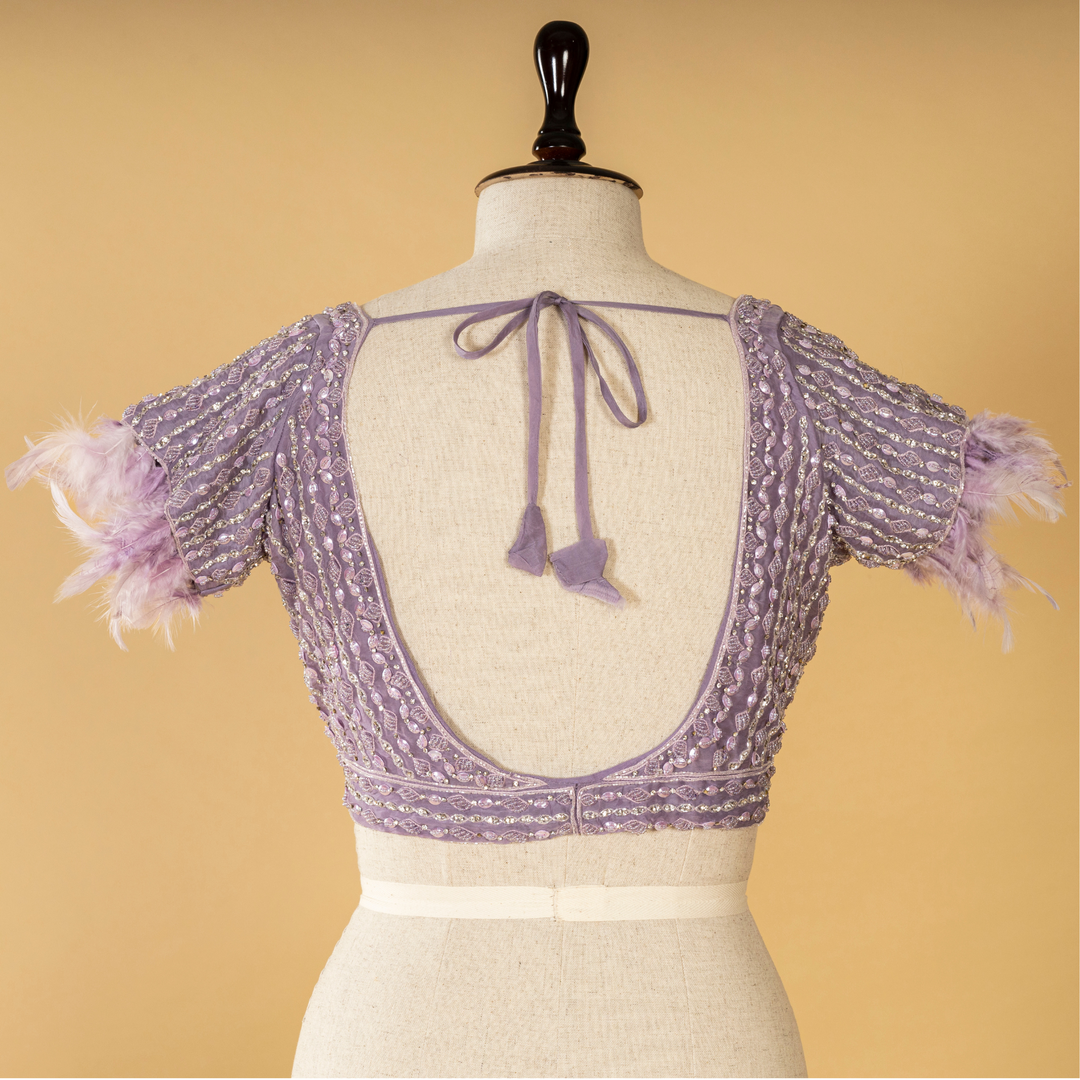 Lilac Tissue embroidered saree paired with feather detailing blouse