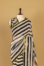 Load image into Gallery viewer, Black &amp; White georgette sequence Saree paired with Embroidered sleeveless blouse

