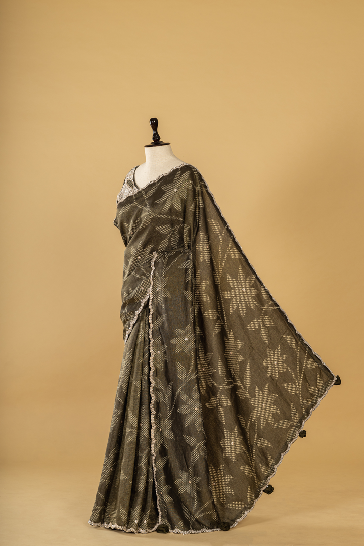 Carbon green bandhej tissue scallop border saree paired with heavy blouse
