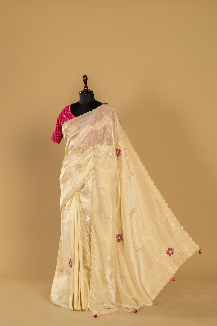 Ivory Tissue applique sequence saree paired with  pink embroidered blouse