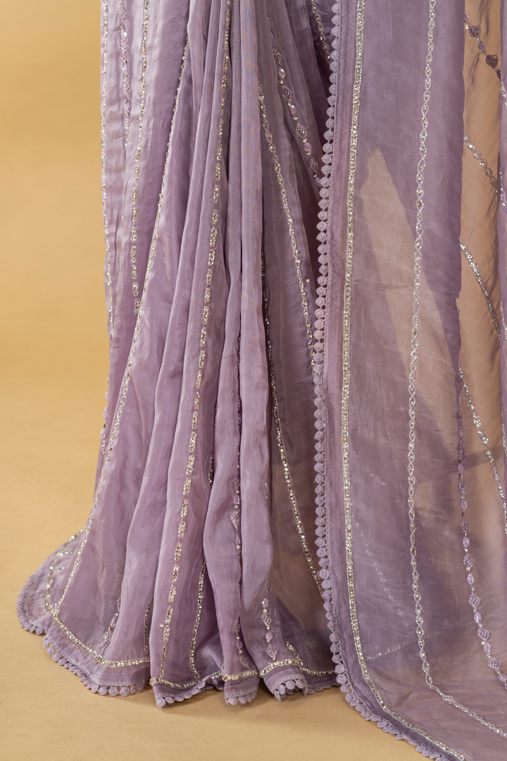Lilac Tissue embroidered saree paired with feather detailing blouse