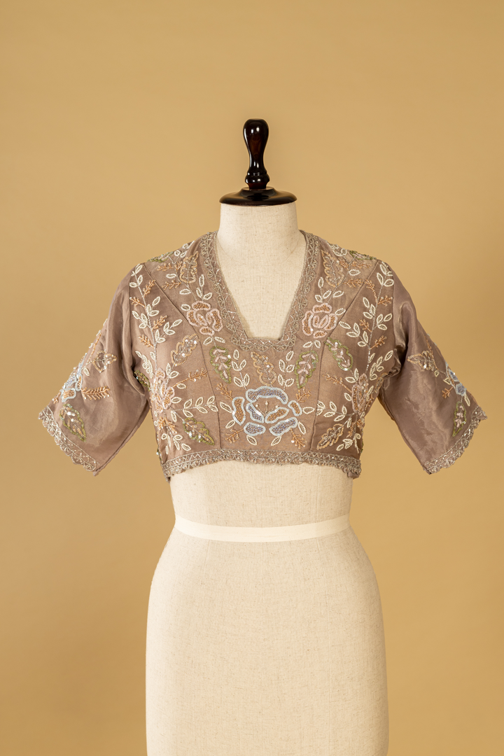 Mauve tissue embroidered saree paired with stitched blouse