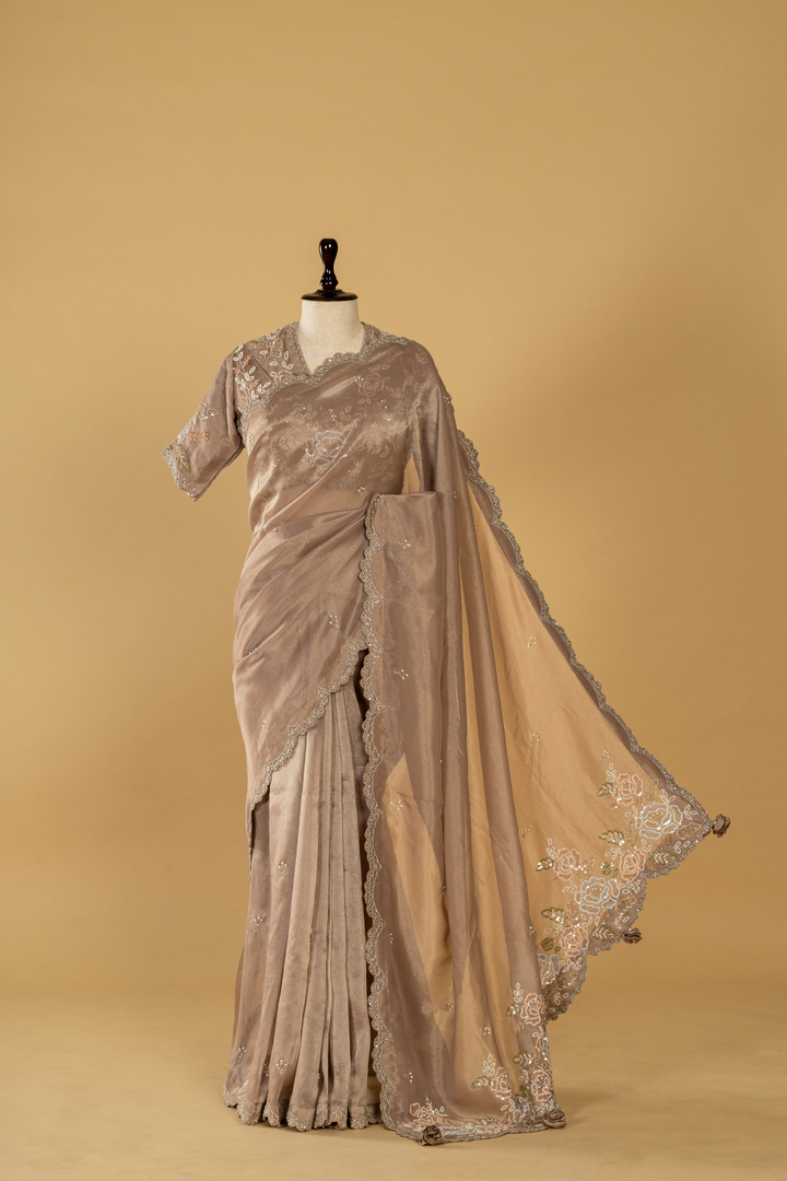 Mauve tissue embroidered saree paired with stitched blouse