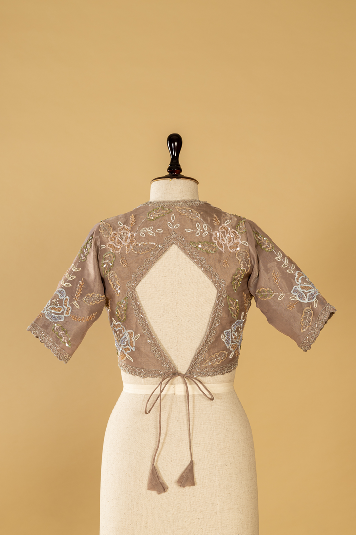 Mauve tissue embroidered saree paired with stitched blouse