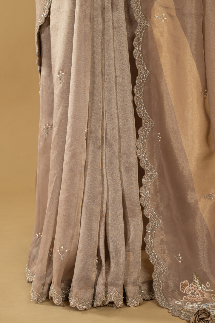 Mauve tissue embroidered saree paired with stitched blouse