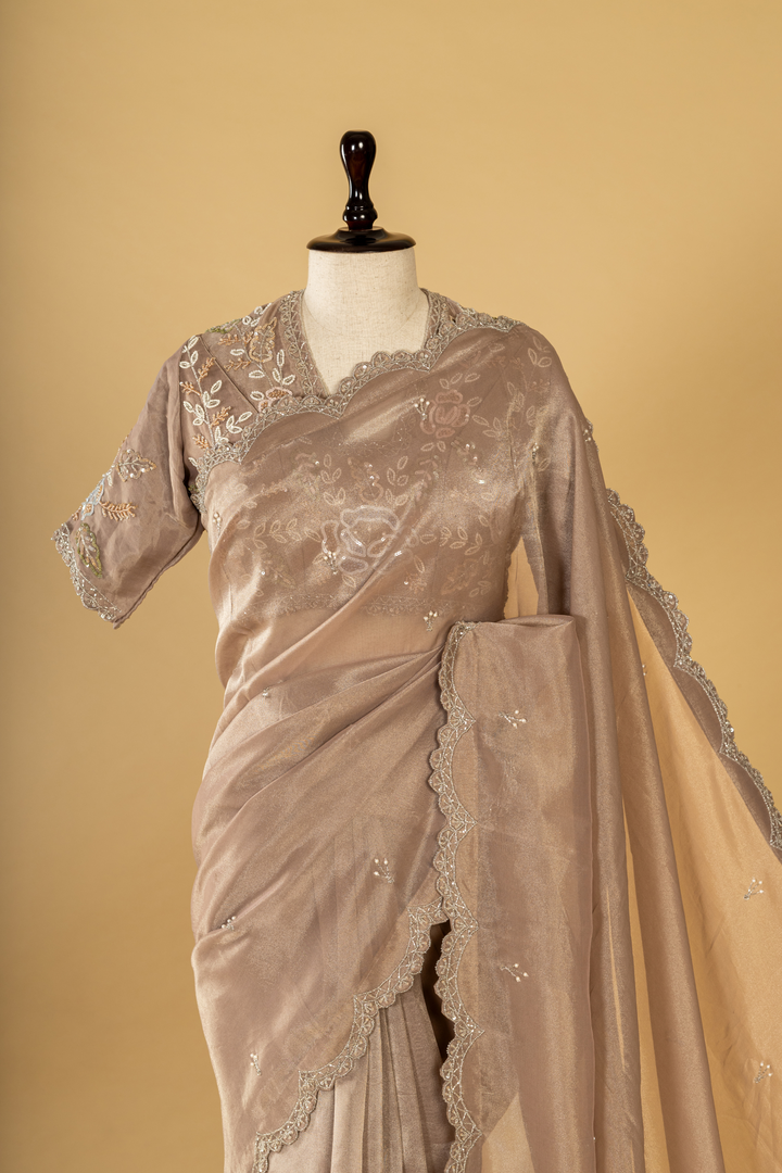 Mauve tissue embroidered saree paired with stitched blouse