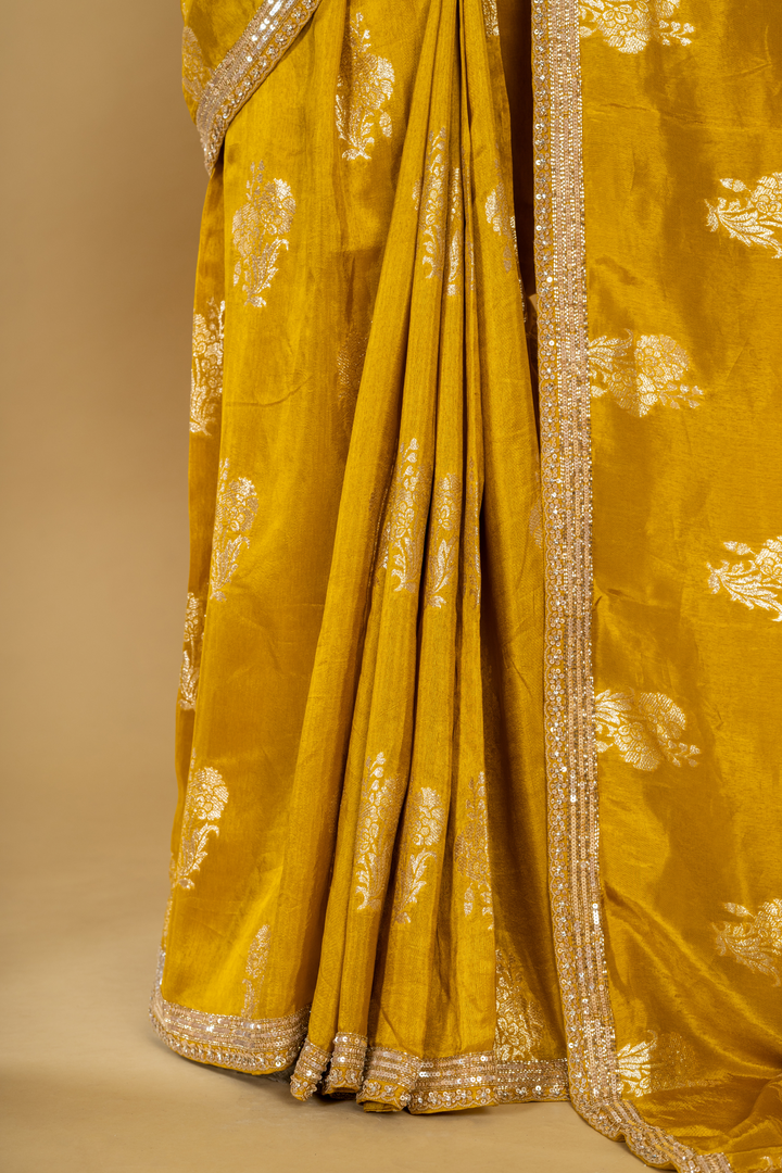 Mustard silk printed border highlighted saree paired with elbow sleeves blouse