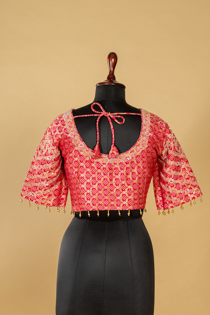 Onion peach tissue saree paired with pink bandhej upada blouse