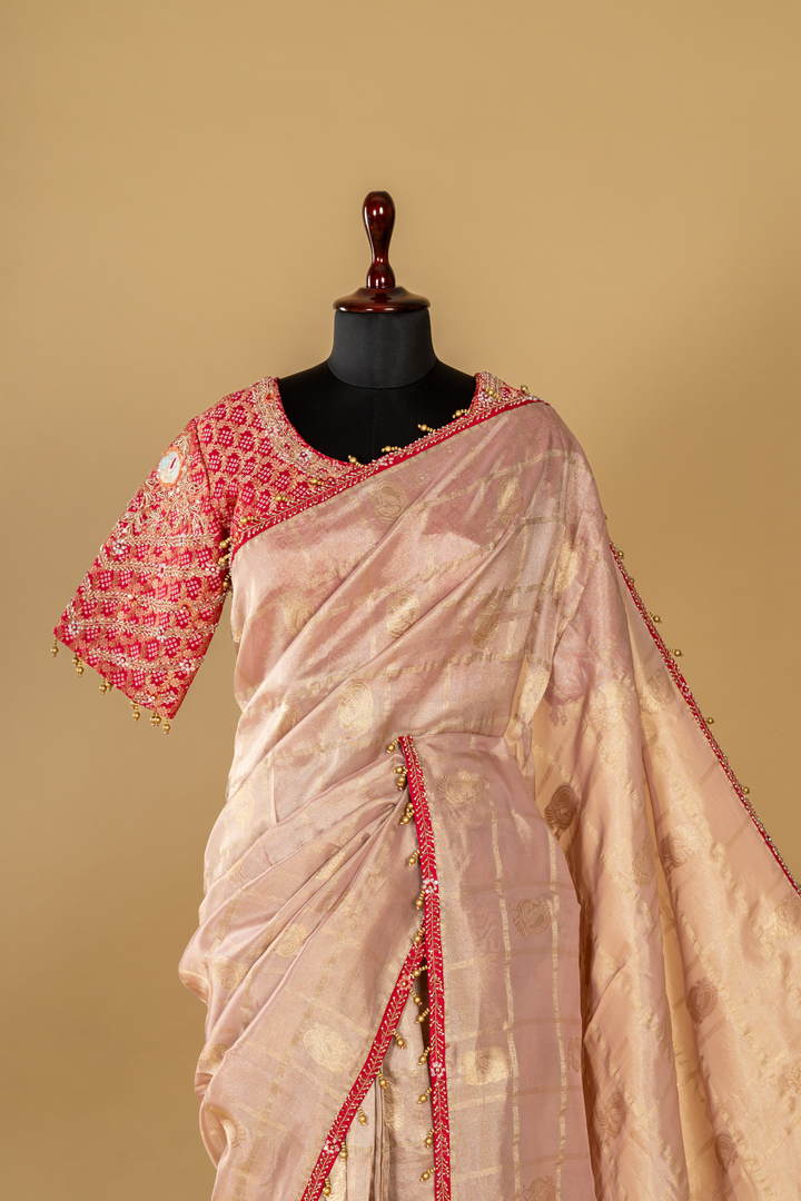 Onion peach tissue saree paired with pink bandhej upada blouse