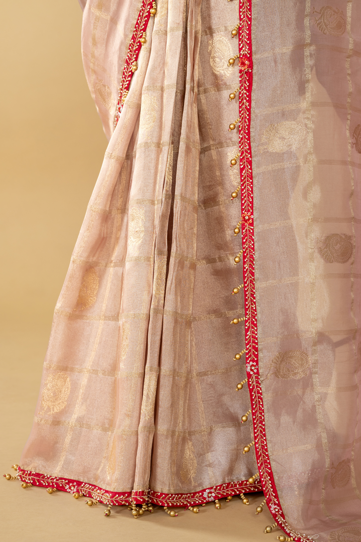 Onion peach tissue saree paired with pink bandhej upada blouse