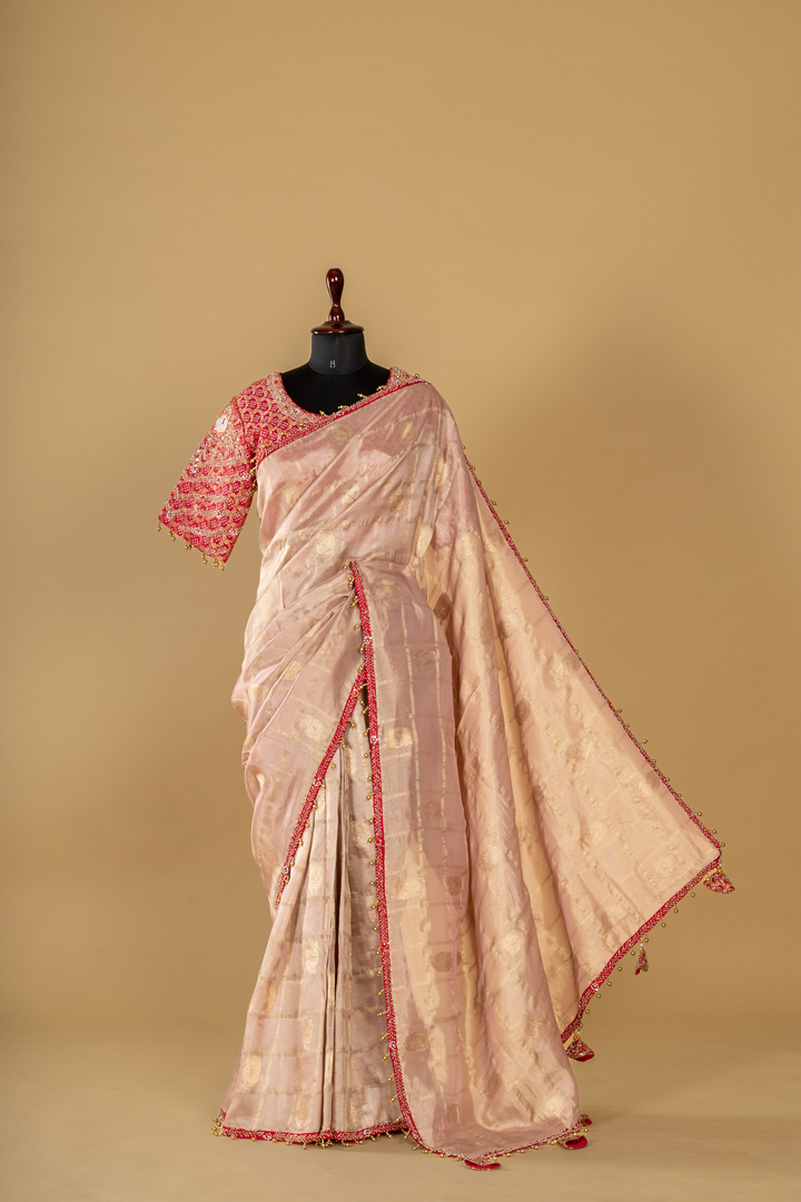 Onion peach tissue saree paired with pink bandhej upada blouse