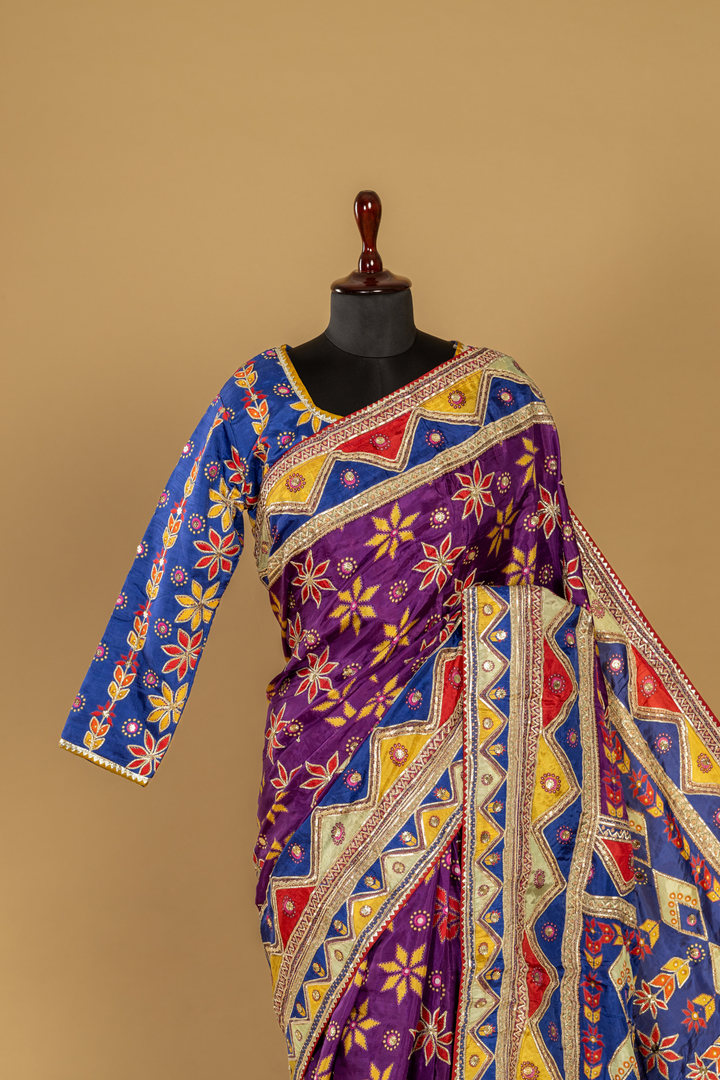 Purple printed saree with gota work highlightment paired with full sleeves contrast blouse