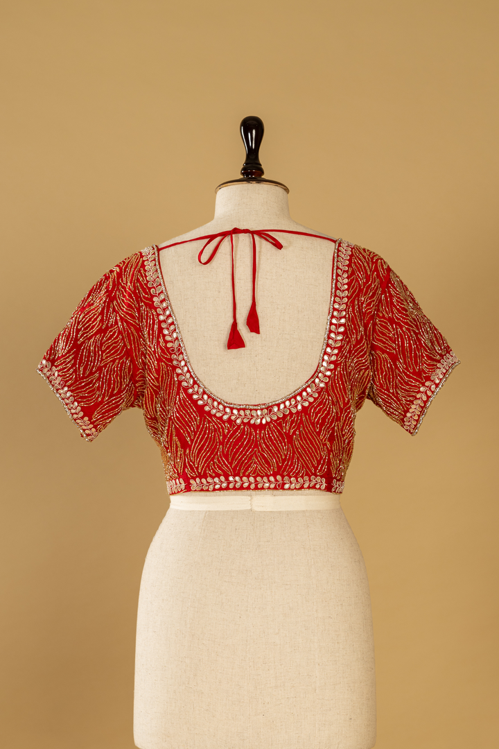Red banarasi tissue gota saree paired with katdana embroidered blouse