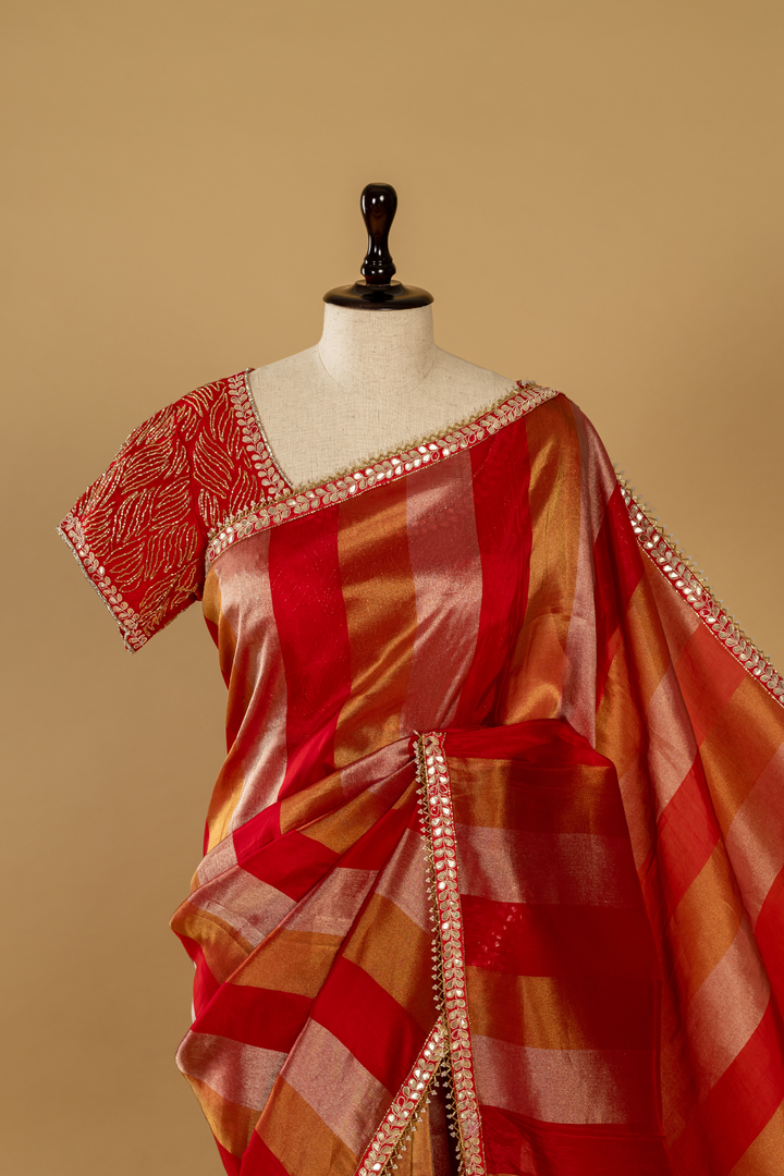 Red banarasi tissue gota saree paired with katdana embroidered blouse