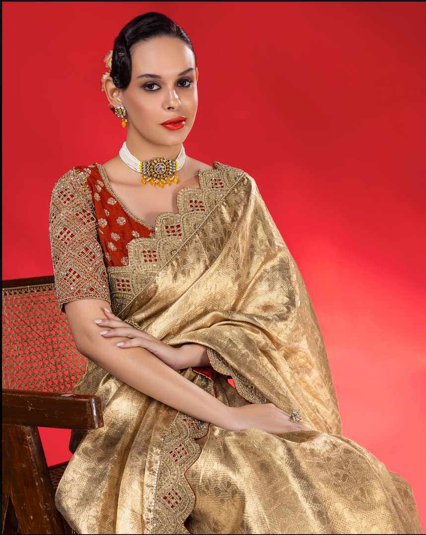 Exude ethereal elegance in this fluid gold tissue Saree