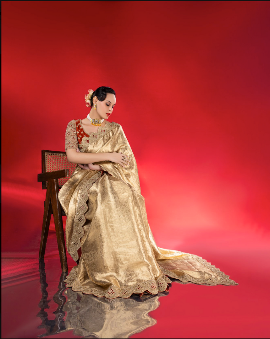 Exude ethereal elegance in this fluid gold tissue Saree
