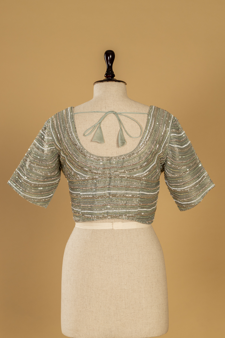 Sea green tissue sequence embroidery saree paired with embroidered stitched blouse