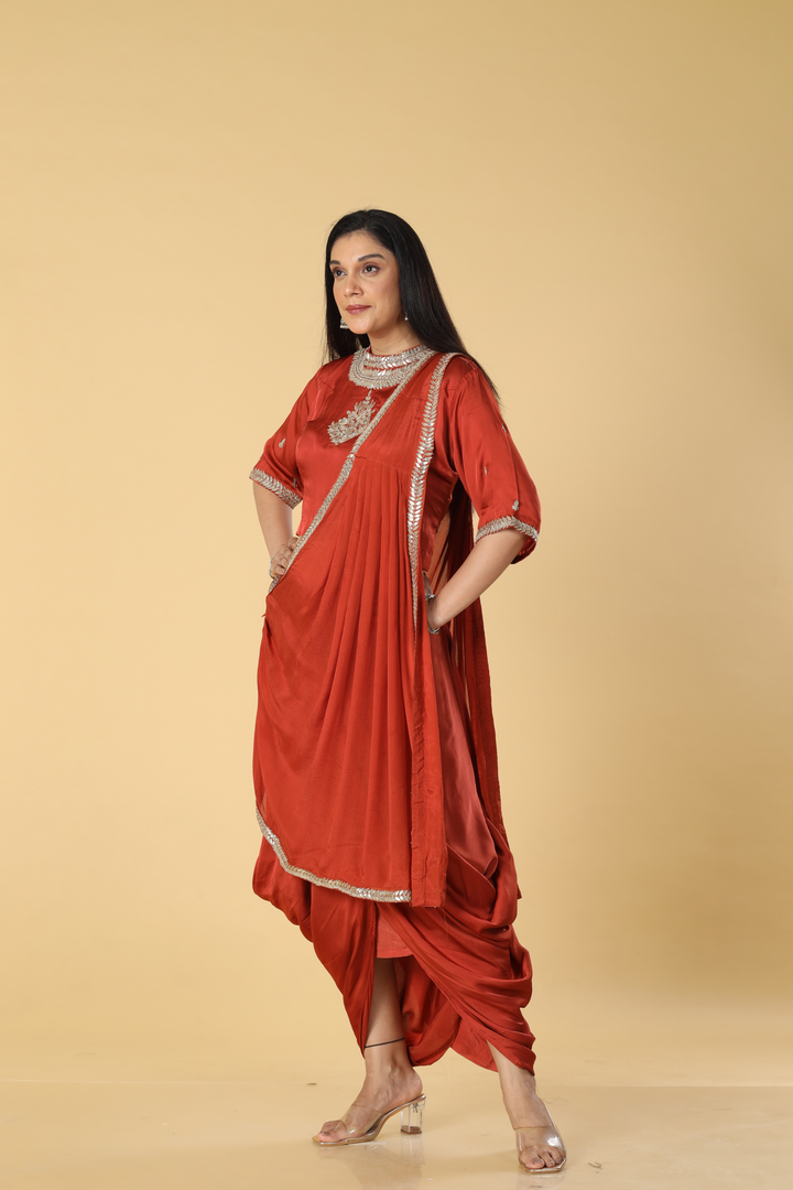 Burnt orange satin organza cowl skirt with gota blouse paired with georgette indowestern