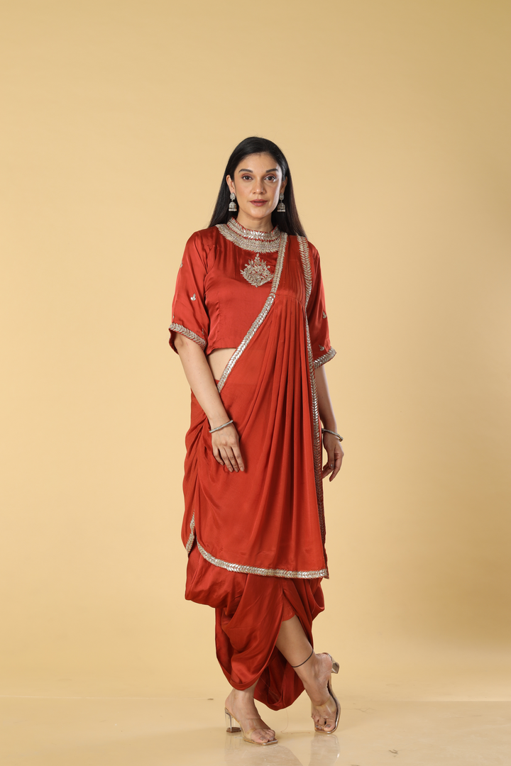Burnt orange satin organza cowl skirt with gota blouse paired with georgette indowestern