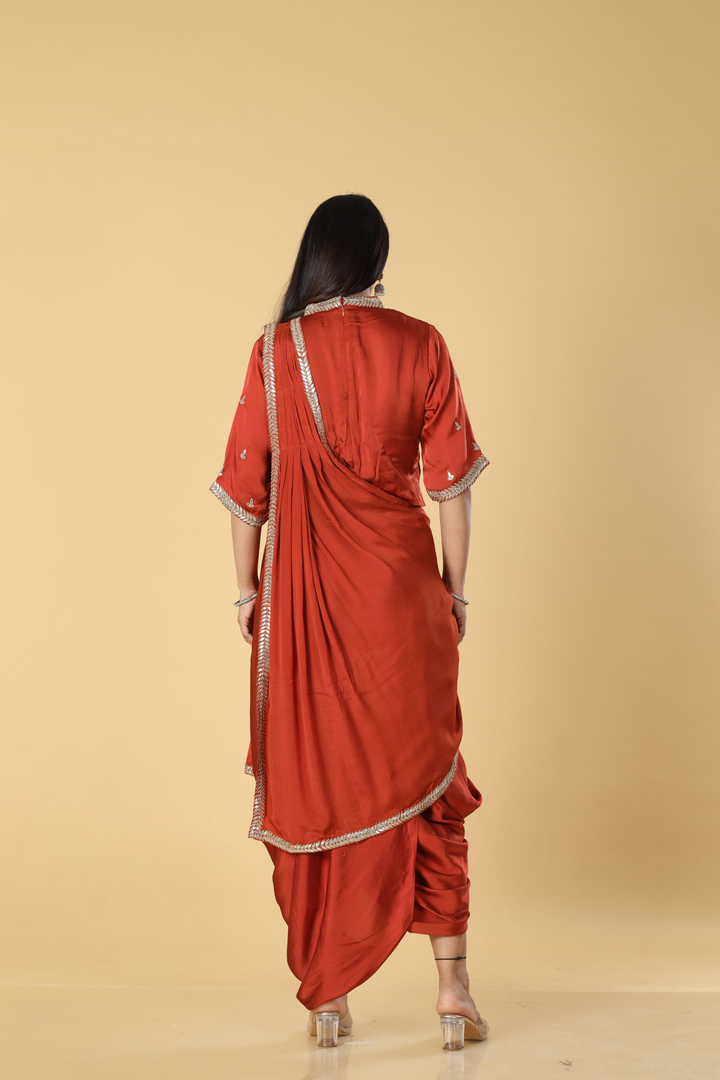 Burnt orange satin organza cowl skirt with gota blouse paired with georgette indowestern