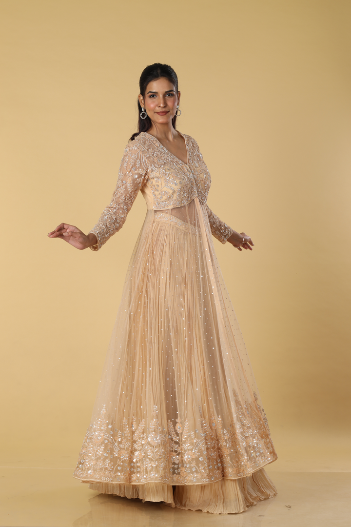 Beige net heavily embroidered indowestern paired with pleated satin organza skirt