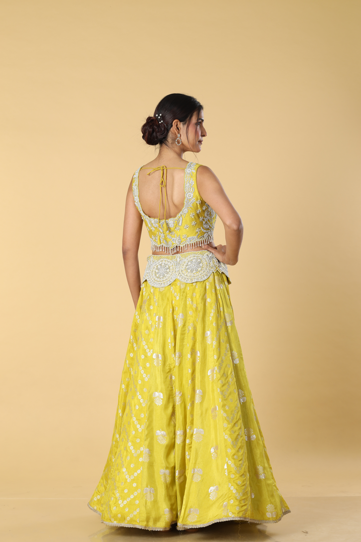 Yellow banarasi lehenga with broad belt paired with raw silk embroidered blouse  and organza dupatta