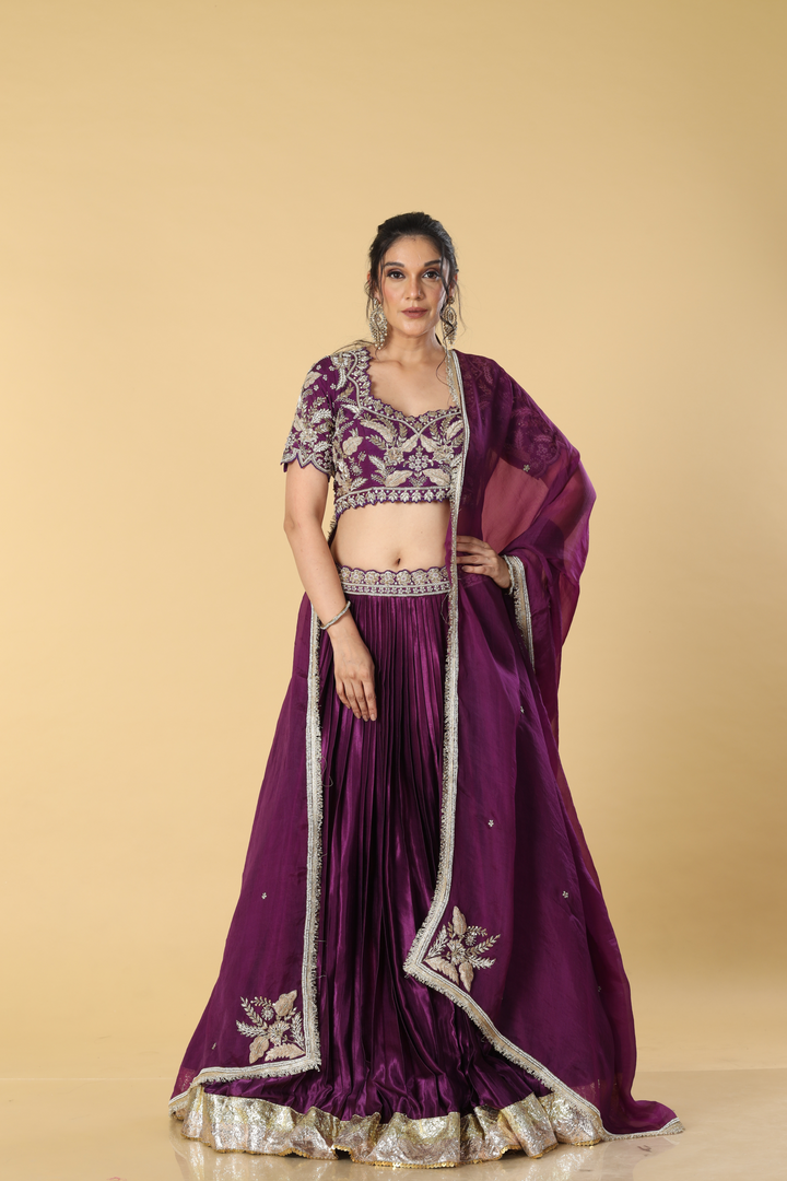 Purple gajji satin zardosi embroidered blouse paired with pleated skirt with border and organza dupatta