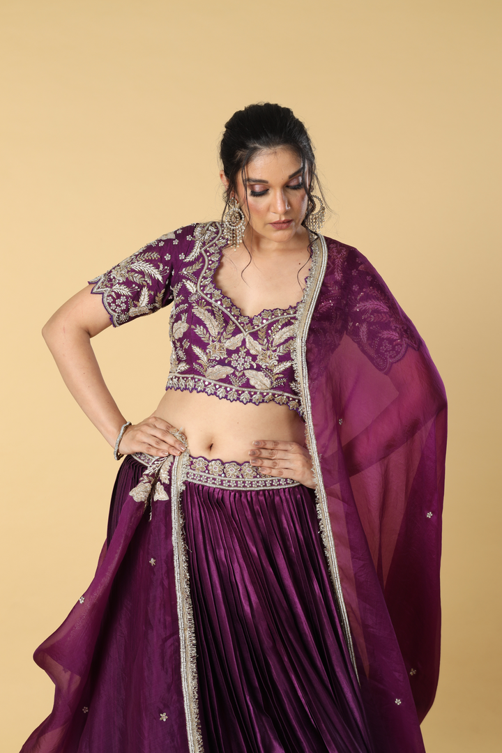 Purple gajji satin zardosi embroidered blouse paired with pleated skirt with border and organza dupatta