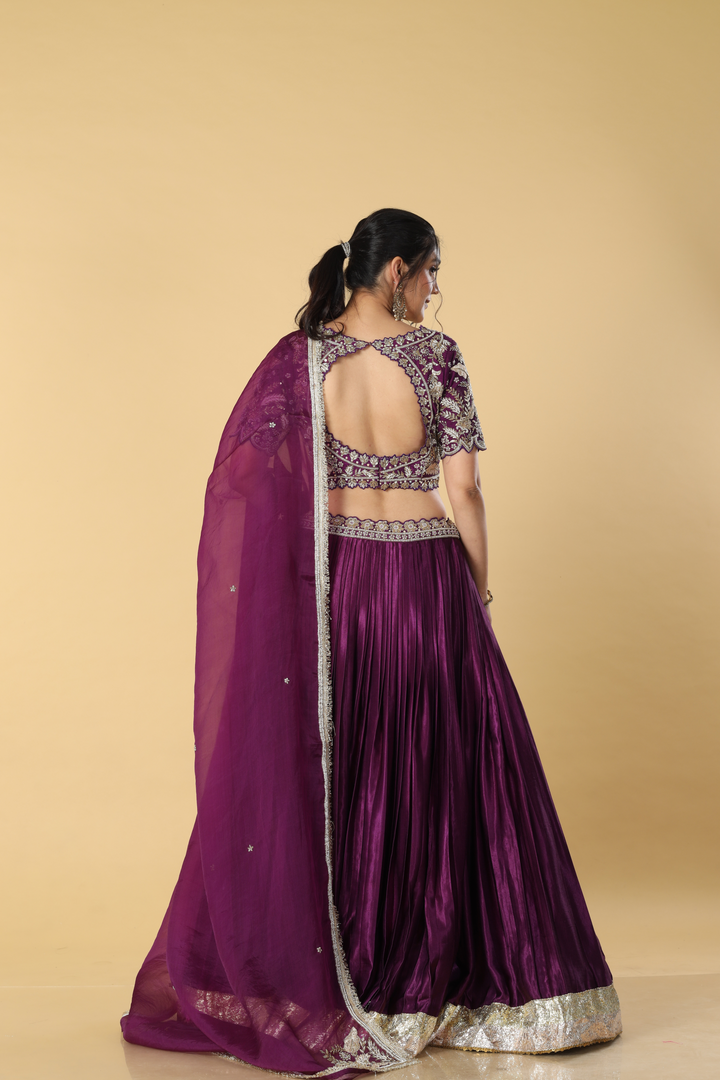 Purple gajji satin zardosi embroidered blouse paired with pleated skirt with border and organza dupatta