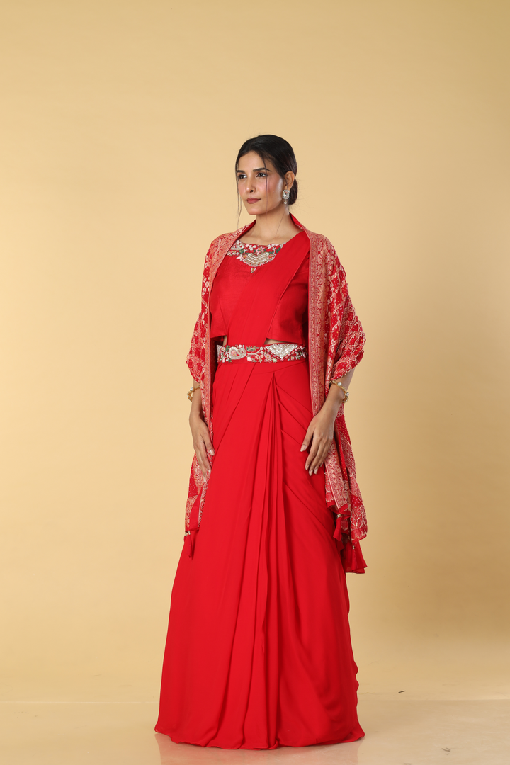 Red D-dupion resham embroidered blouse paired with georgette skirt  and embroidered banarasi bandhej cape