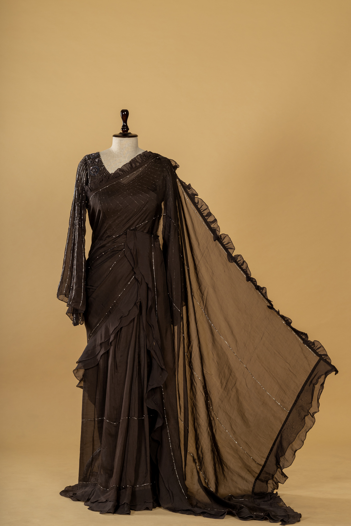 black georgette organza ruffle saree paired with bell sleeves blouse