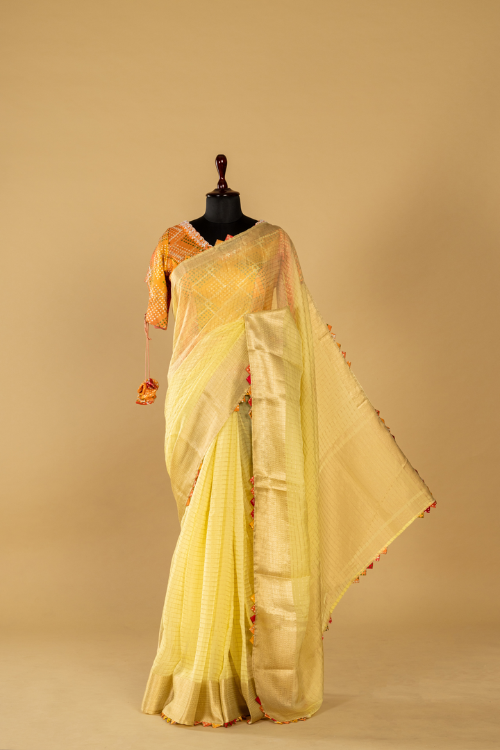 lemon yellow banarasi saree paired with designer long short contrast blouse