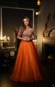 Traditional red orange conceptual lehenga paired with artistic embroidery