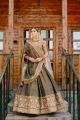 Green Sabyasachi lehenga paired with stylish blouse and a heavy dupatta 